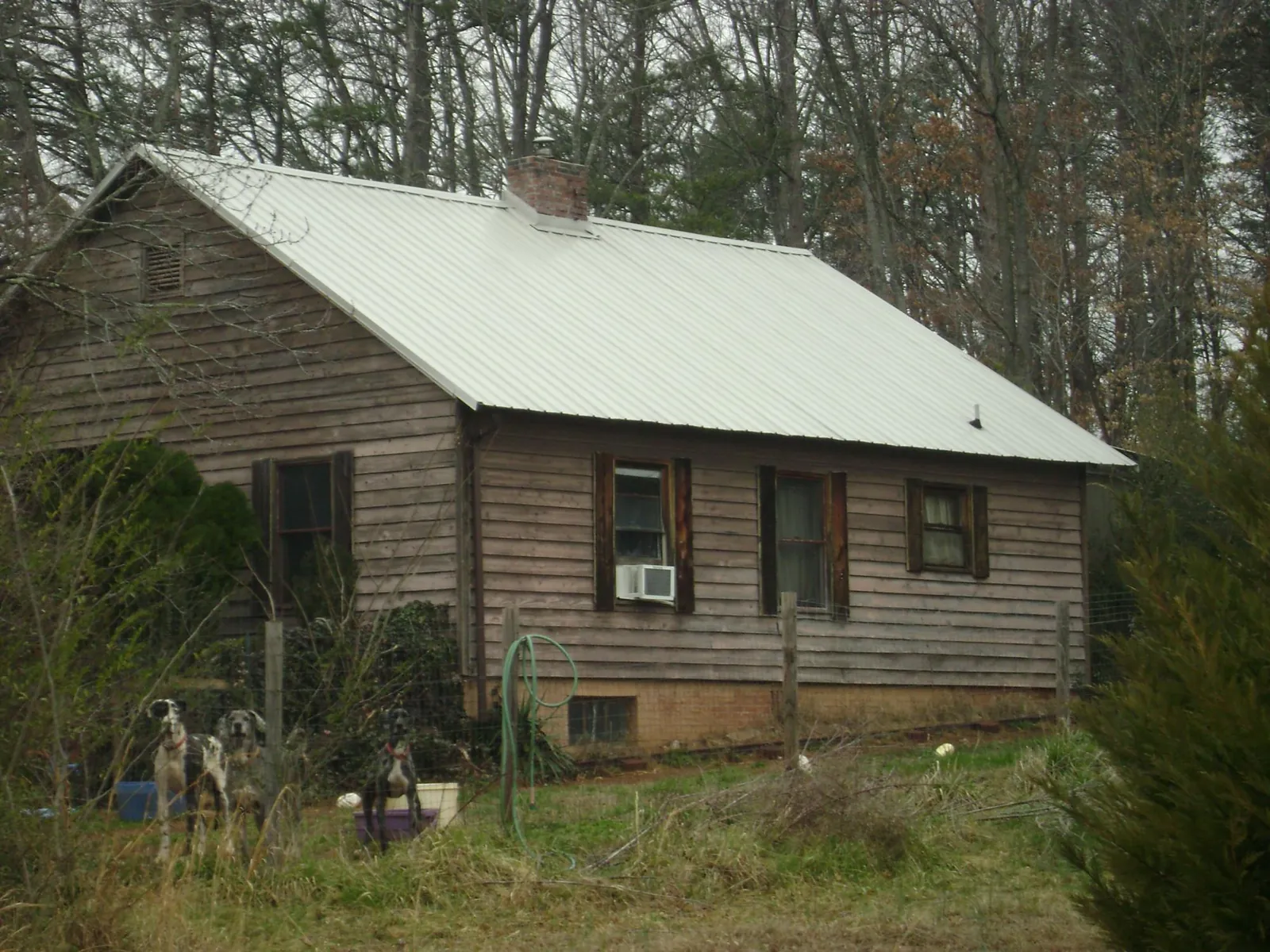 White metal roof on an old wood sided farmhouse, from a Metal Roof Installation job in Perrysburg